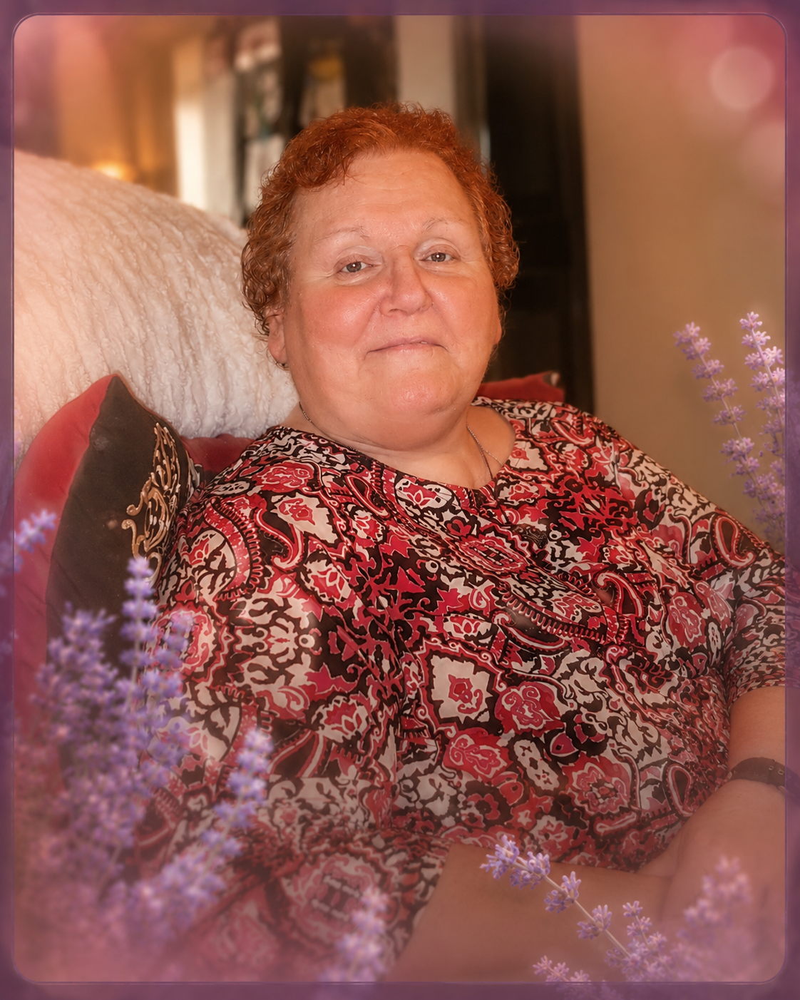 Gail relaxing at home in a red patterned blouse