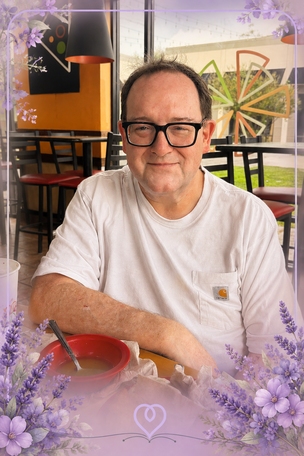 Randall seated at a restaurant table, looking toward the camera